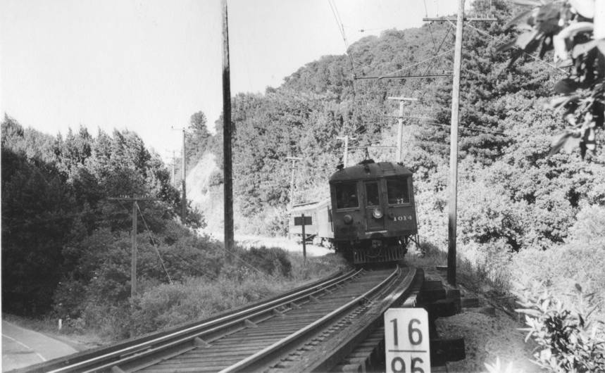 00_28
Train 27 at the east end of Redwood Canyon heading west towards Pinehurst. This is the Canyon Rd overpass. Pittsburg-SF local. June 1941. See what this spot looks like now. Click [url=http://www.bayarearailfan.org/gallery/sn/rowcrossover]here[/url] Ph
