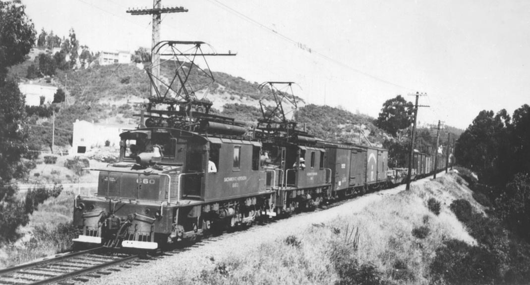 SNfreight
SN motors 660 and 661 lead a westward freight through the Montclair district in Oakland. This is just west of the bridge across Mountain Blvd. (the street shown in the background). <i>Courtesy of John Stashik</i>
