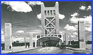 Sacramento_Tower_Bridge_1935
This is the West end of the Tower Bridge in Sacramento, as it appeared for its grand opening in 1935.
