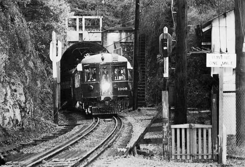 eastport1003
The best shot I've ever seen of the east portal of the Oakland Hills tunnel. This is a Bay Area Electric Railroad Association excursion taken in January 1957. Perhaps the very last passenger train through this tunnel. Photo courtesy of Donald Duke from t
